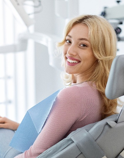 Woman smiling while sitting in treatment chair