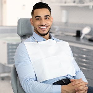 Patient smiling while sitting in treatment chair
