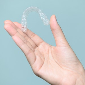 Patient holding clear aligner