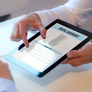 Patient reviewing dental insurance form on tablet