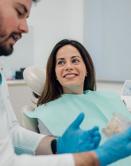 Dentist holding dentures