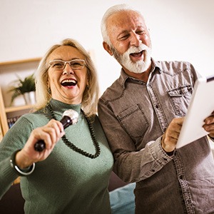 A couple singing while wearing dentures