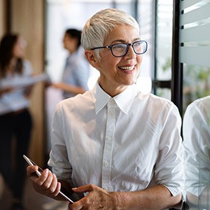 A woman wearing dentures at work