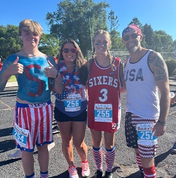 Doctor Jared and his family in patriotic workout clothes at a race