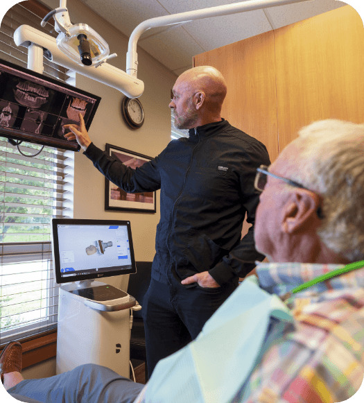 dentist showing images to patient